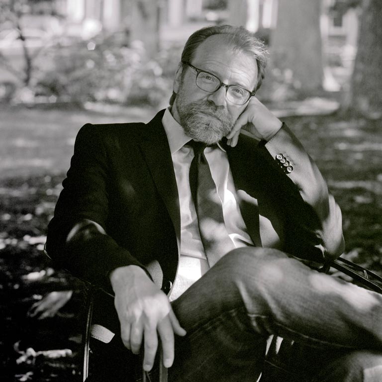 George Saunders sitting on a park bench